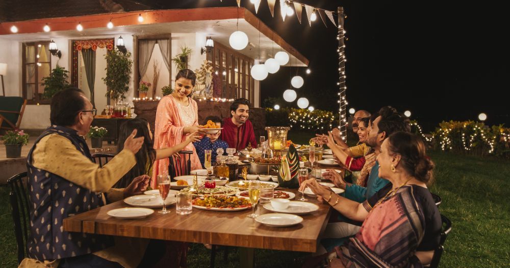 Big Family Celebrating Diwali: Indian Family in Traditional Clothes Gathered Together on a Dinner Table