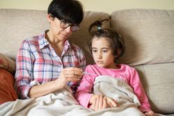 Mother nursing her sick daughter