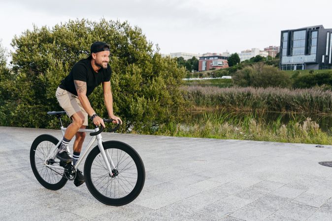 Man riding bicycle on city roadway