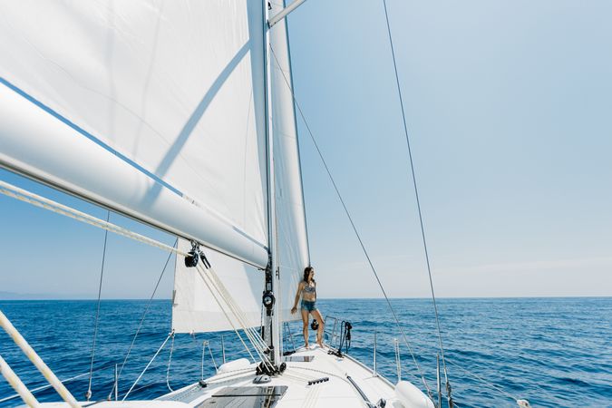 Woman in swimsuit standing on boat