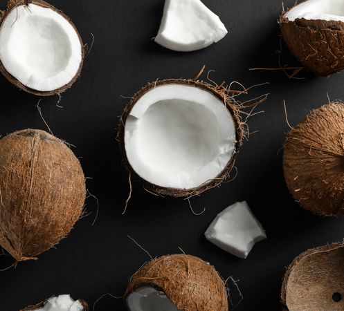 Flat lay composition with coconuts on dark background
