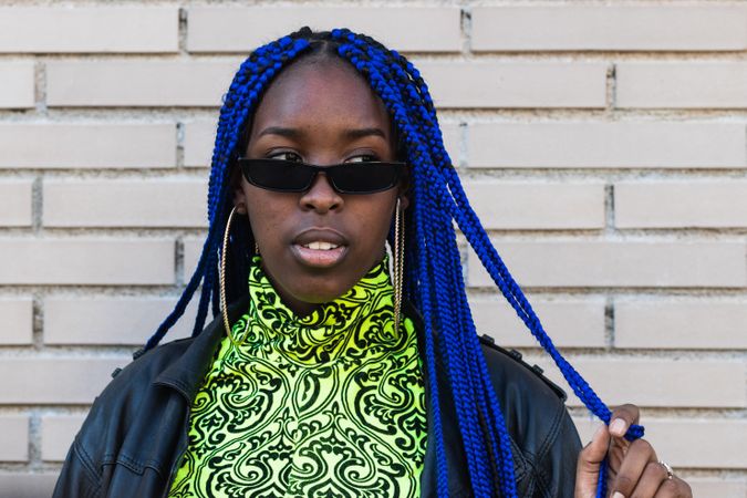 Determined Black woman in trendy clothes in city