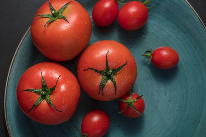 Closeup of ripe tomatoes placed in a plate
