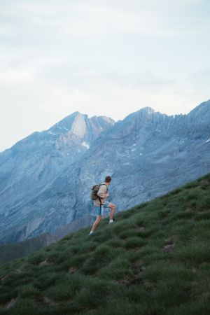Unrecognizable man with backpack hiking in Pyrenees mountains