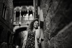 Adult woman leaning on old stone wall