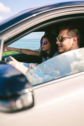 Young man driving a car with his girlfriend