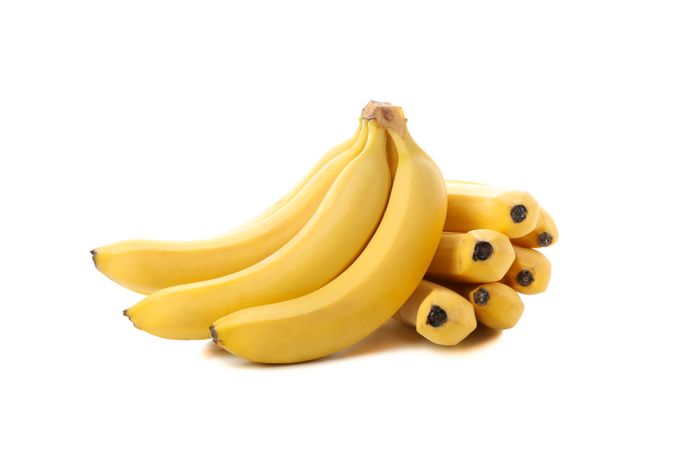 Banana cluster isolated on light background. Fresh fruit