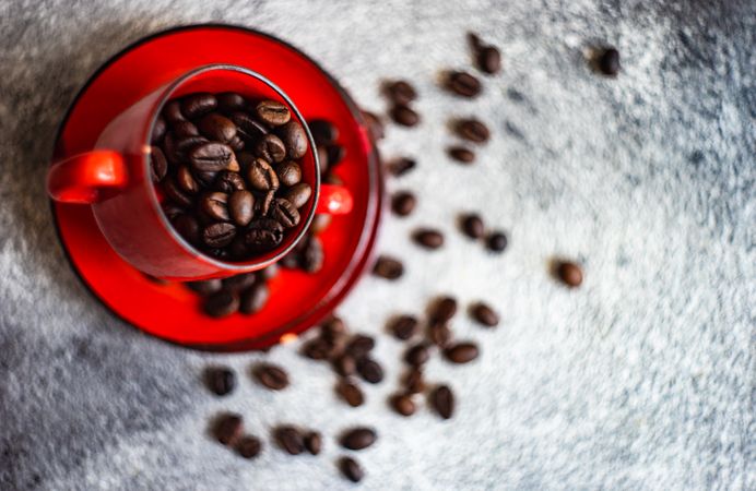 Top view of red cup full of coffee beans