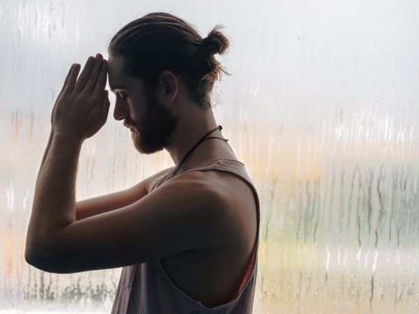 Man in mindfulness on window sill