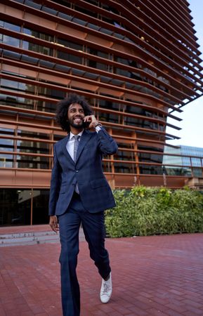 smiling businessman talking on smartphone