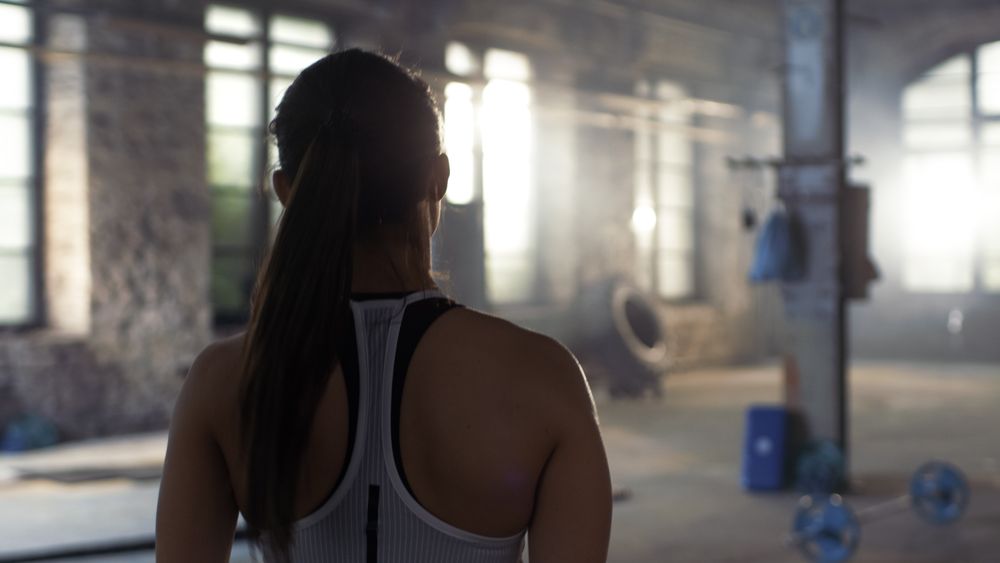 Shot from the back of Athletic Woman Entering Gym. She's Confident