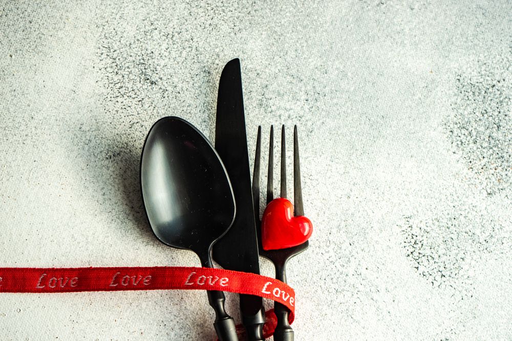 Table setting with heart resting on silverware