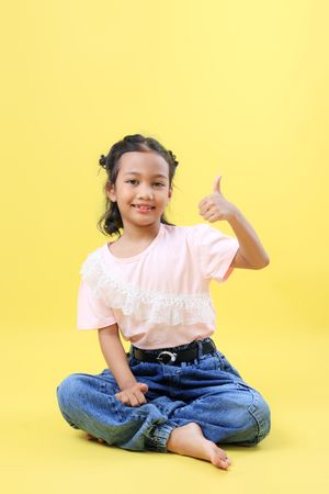 Asian Kid Sit and Thumbs Up