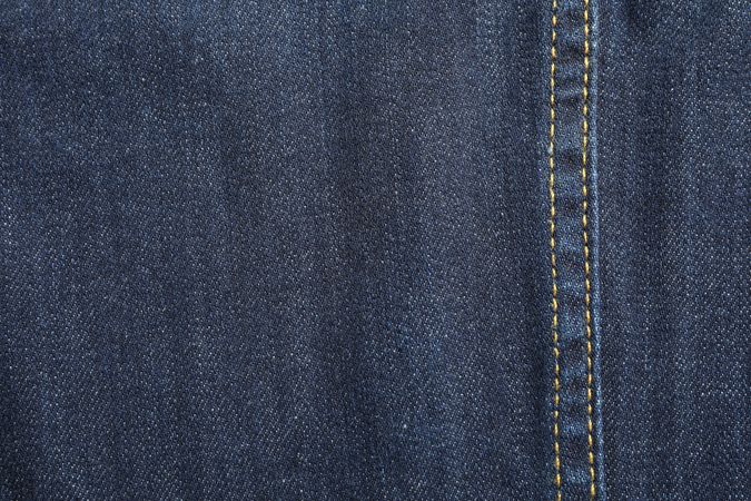 Texture of blue jeans as background, space for text