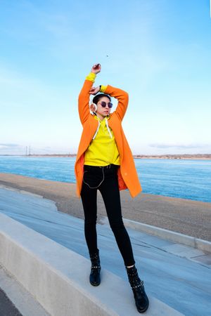 Woman with headphones on the coast