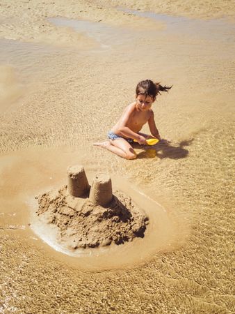 little girl building a sand castle