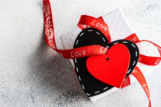 Giftbox wrapped in red ribbon with heart tag