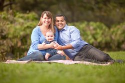 Happy Family Having a Picnic and Playing In The Park