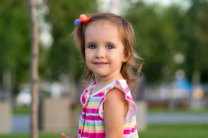 Toddler smiling outdoors