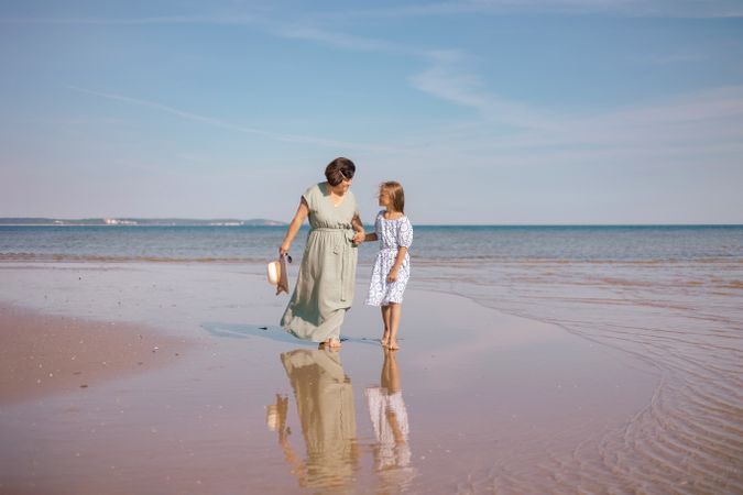 Beach stroll with mother and daughter