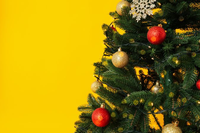 Christmas tree on yellow background, space for text