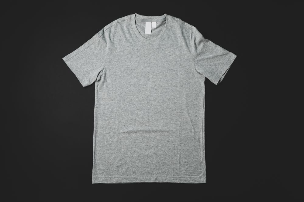 Blank gray t-shirt on dark background, space for text