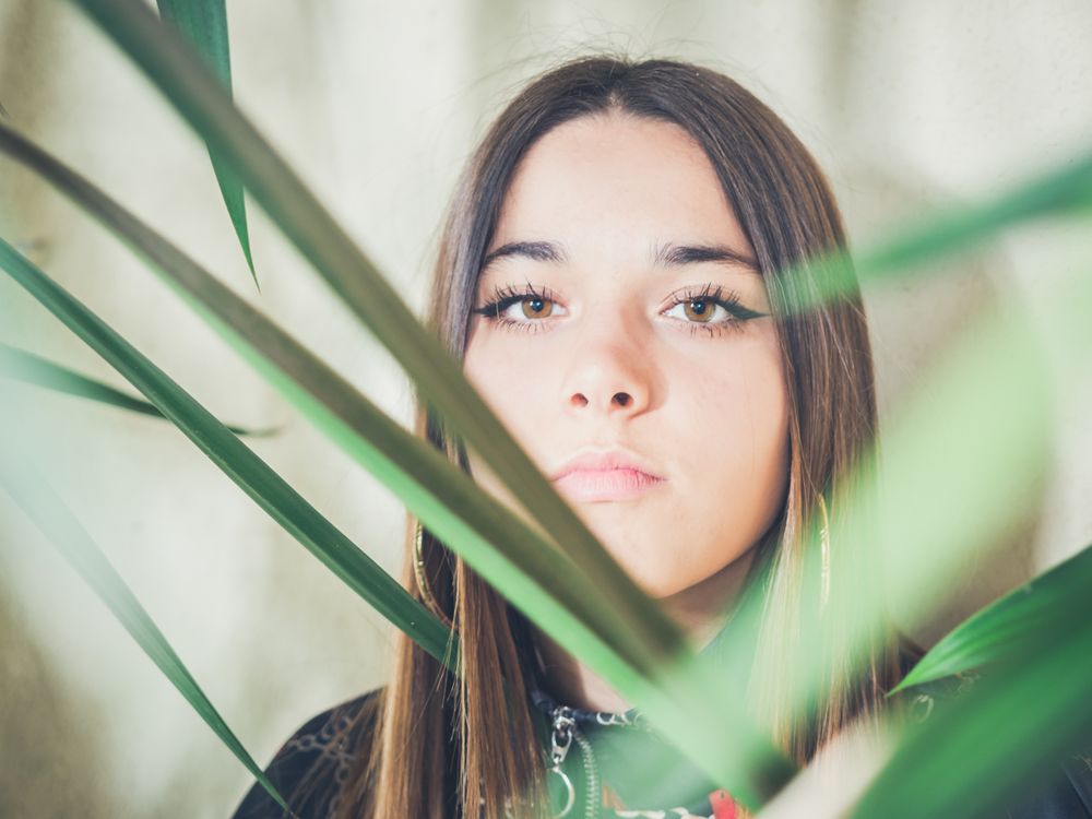 Woman between green leaves