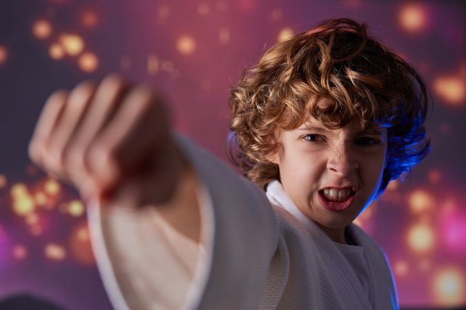 Aggressive boy punching air during judo training