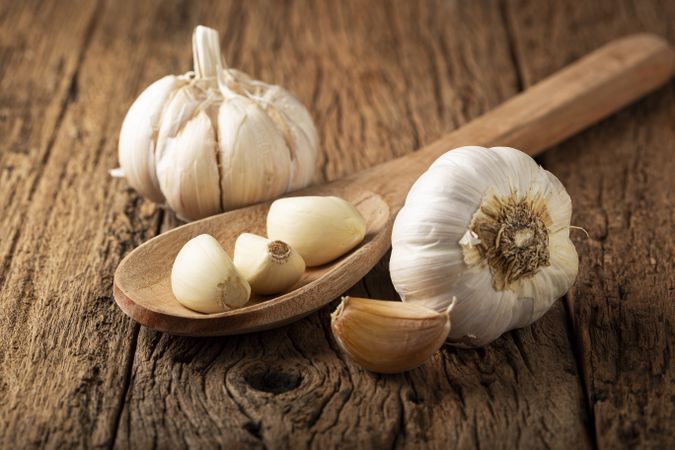 Garlic bulb and garlic cloves on the wooden table.