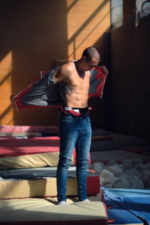 Young sports gymnast putting on her sports clothes for training.