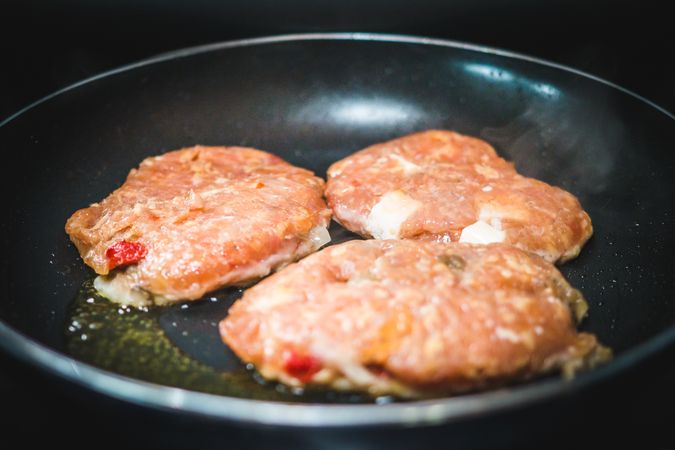 Meat cutlets frying on pan