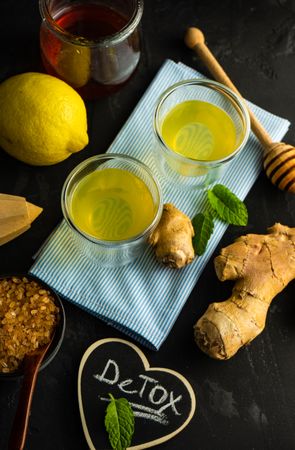 Detox shots on napkin with lemon, ginger and mint on napkin