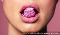 Beautiful pink lips with a piece of sweet candy 5k2Kj0