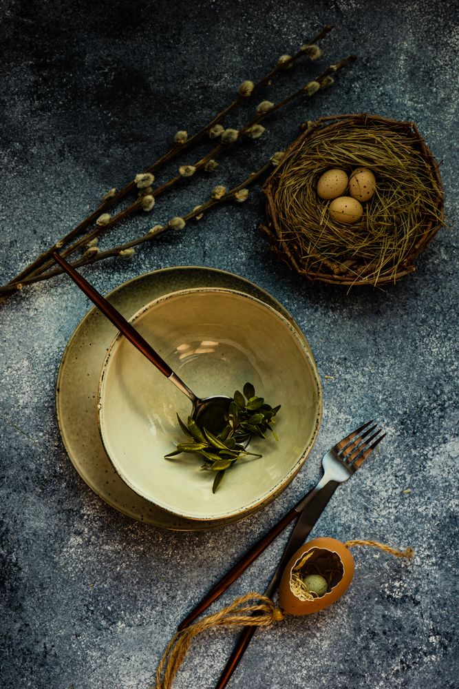 Easter holiday table setting with bowl of branches, nest, and pussy wlllow