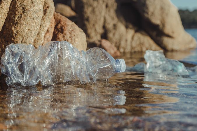 Plastic bottle lying on seashore