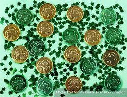 St Patrick’s Day with shamrocks and shiny coins on green background bE3jl5