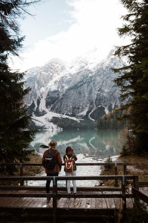Resting couple taking photo of lake and mountains