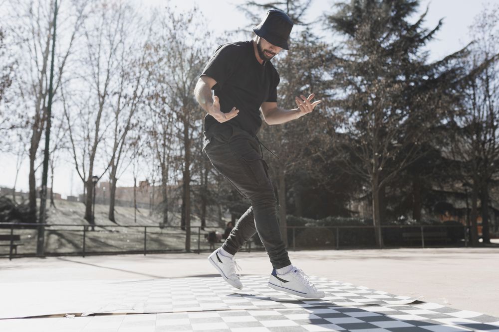 Man dancing break dance in park