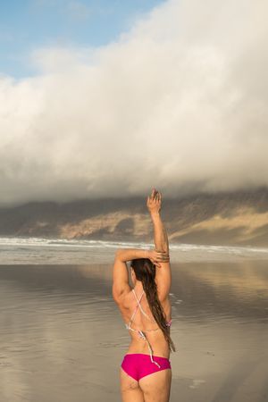 Woman stretching near sea