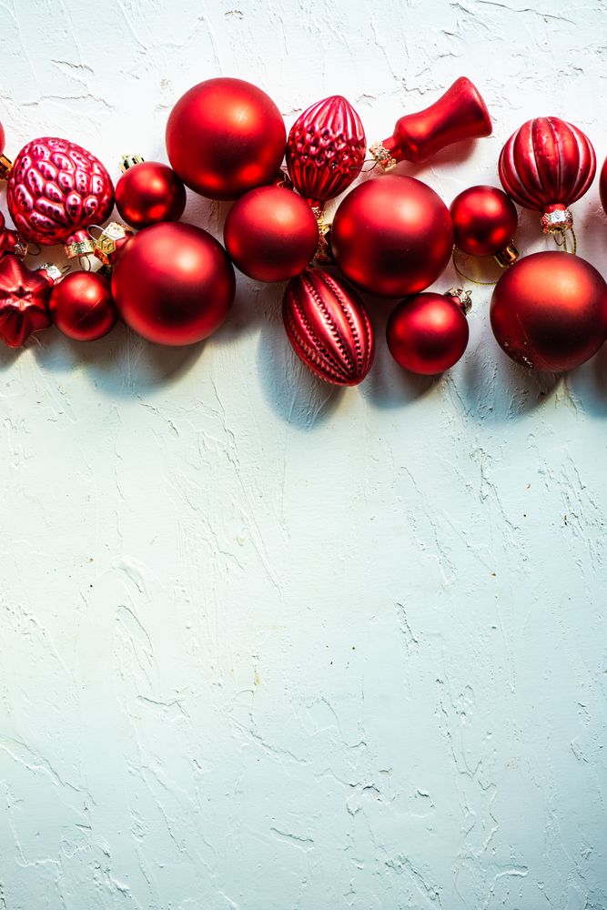 Christmas red baubles in line at top of picture