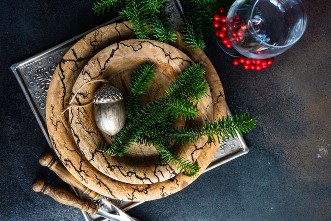 Rustic plates, cutlery and glass with xmas pine and ornament