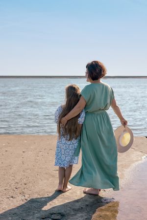 Mother and daughter by the sea