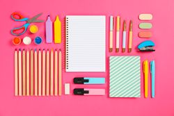 Flat lay composition with stationery on pink background, space for text