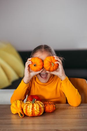 Little Girl Playing With a Pumpkin.