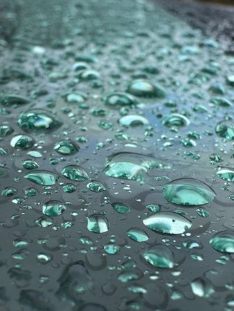 A wet surface with many small drops of water on it