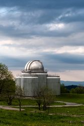Large observatory dome under cloudy sky