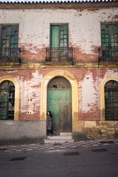 Woman on street with aged building