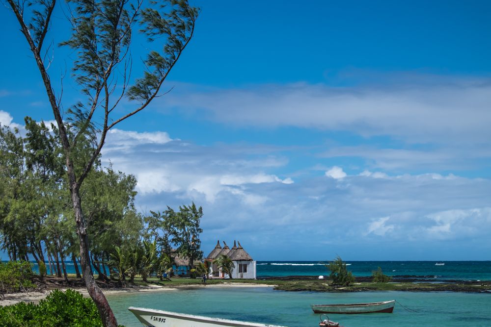 Scene of fishing boats anchored in the sand in Mauritius