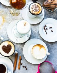 Top view of a variety coffees with foam art