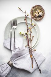 Festive table setting with cherry blossom branch and nest